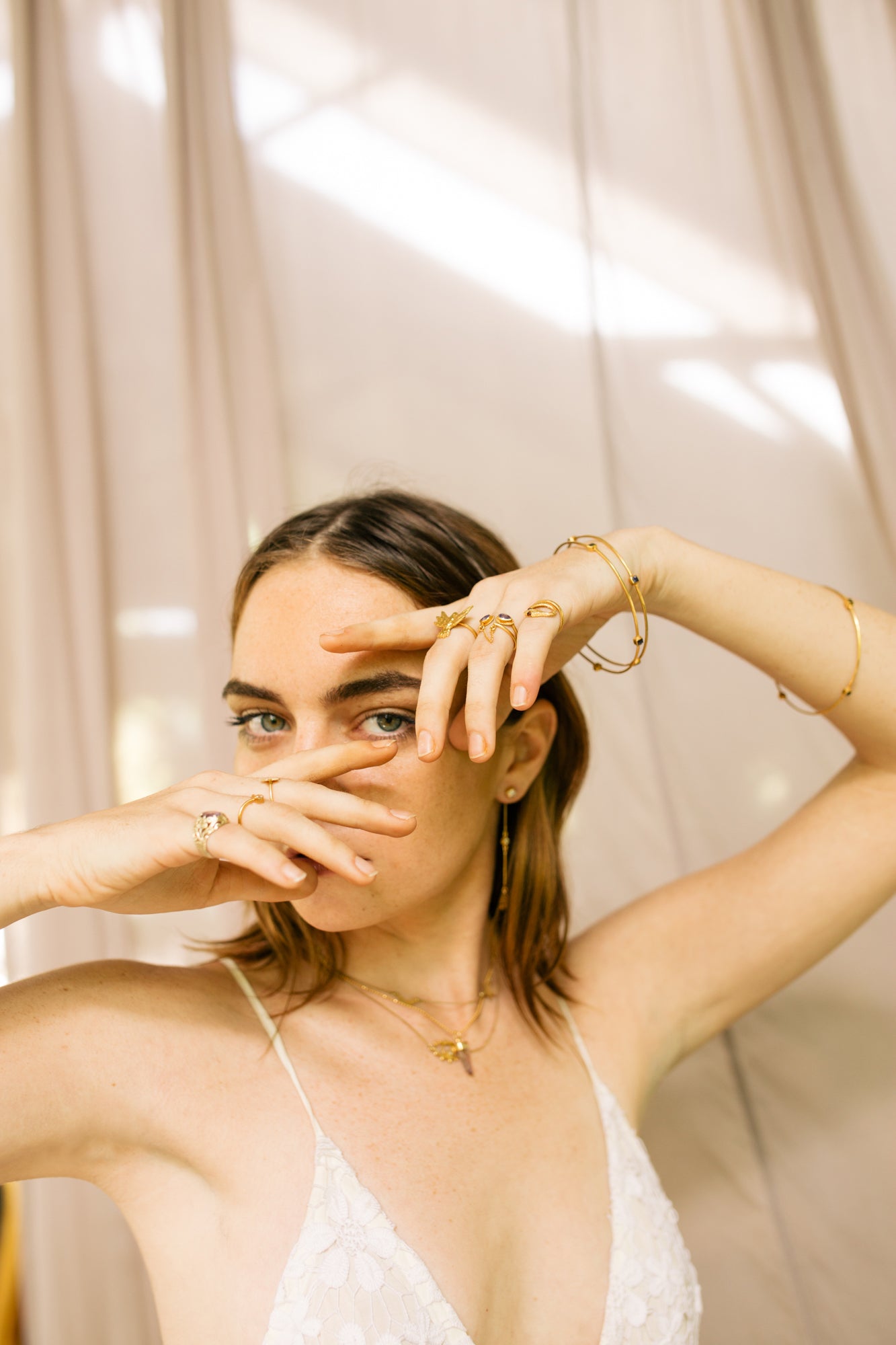 handmade gold drop ring on model