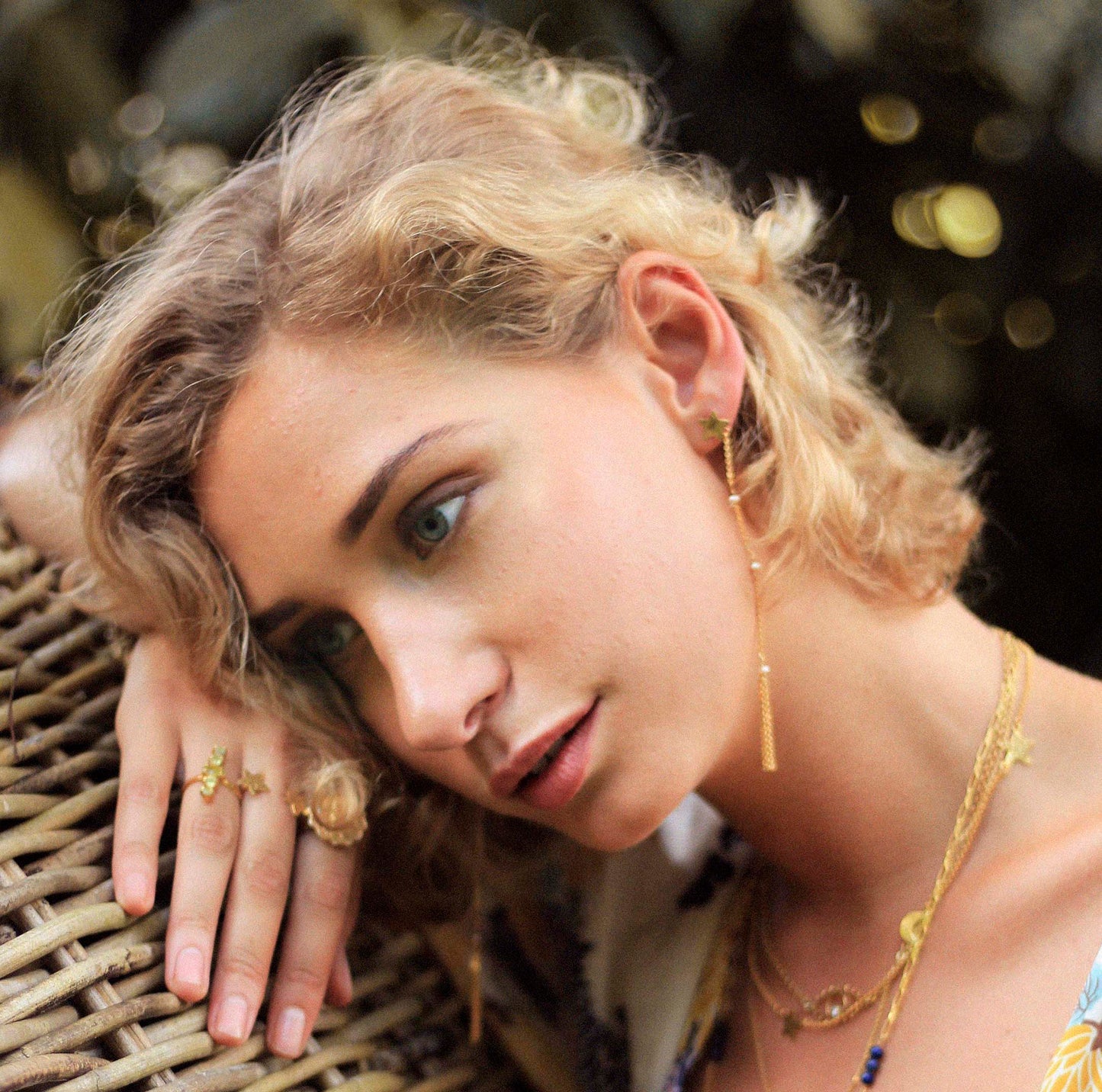 star and pearls chain gold earrings on model