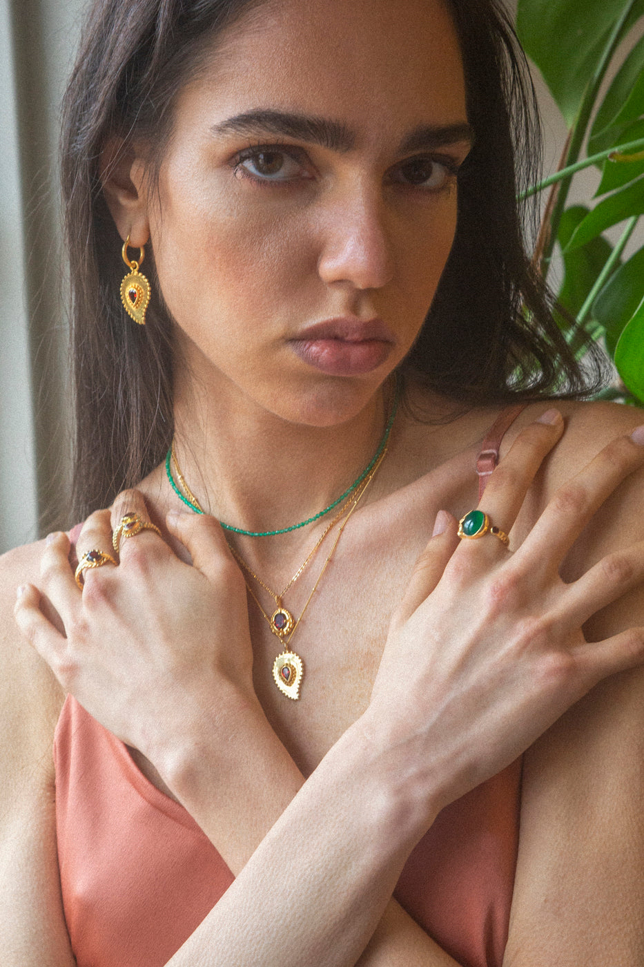 Small gold circle earrings with garnet pendant