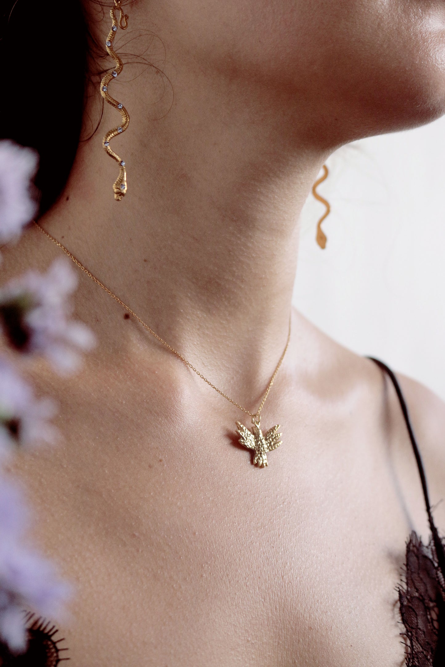 Gold bird necklace and snake earrings   on model