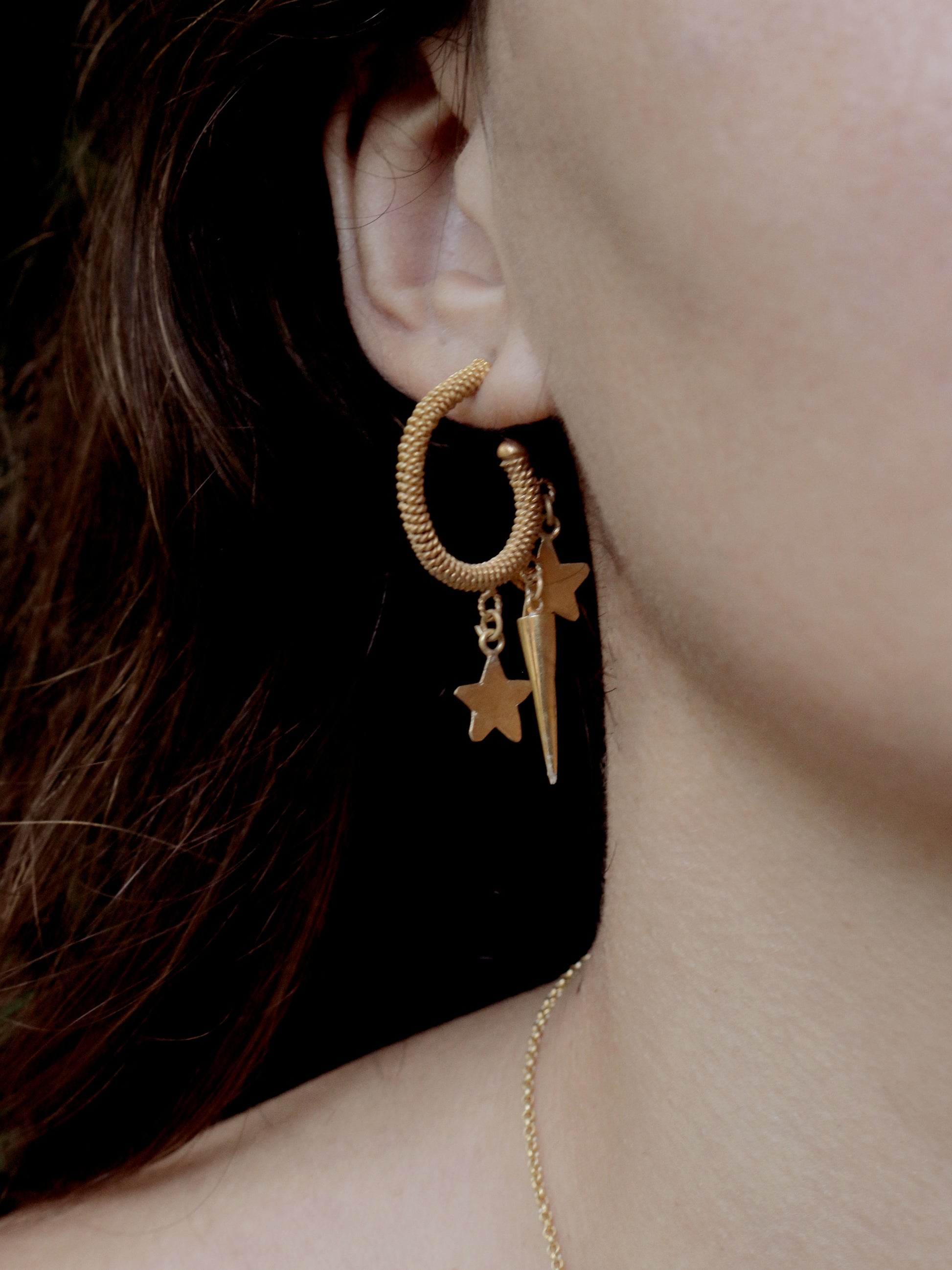 Handmade gold hoops earrings on model