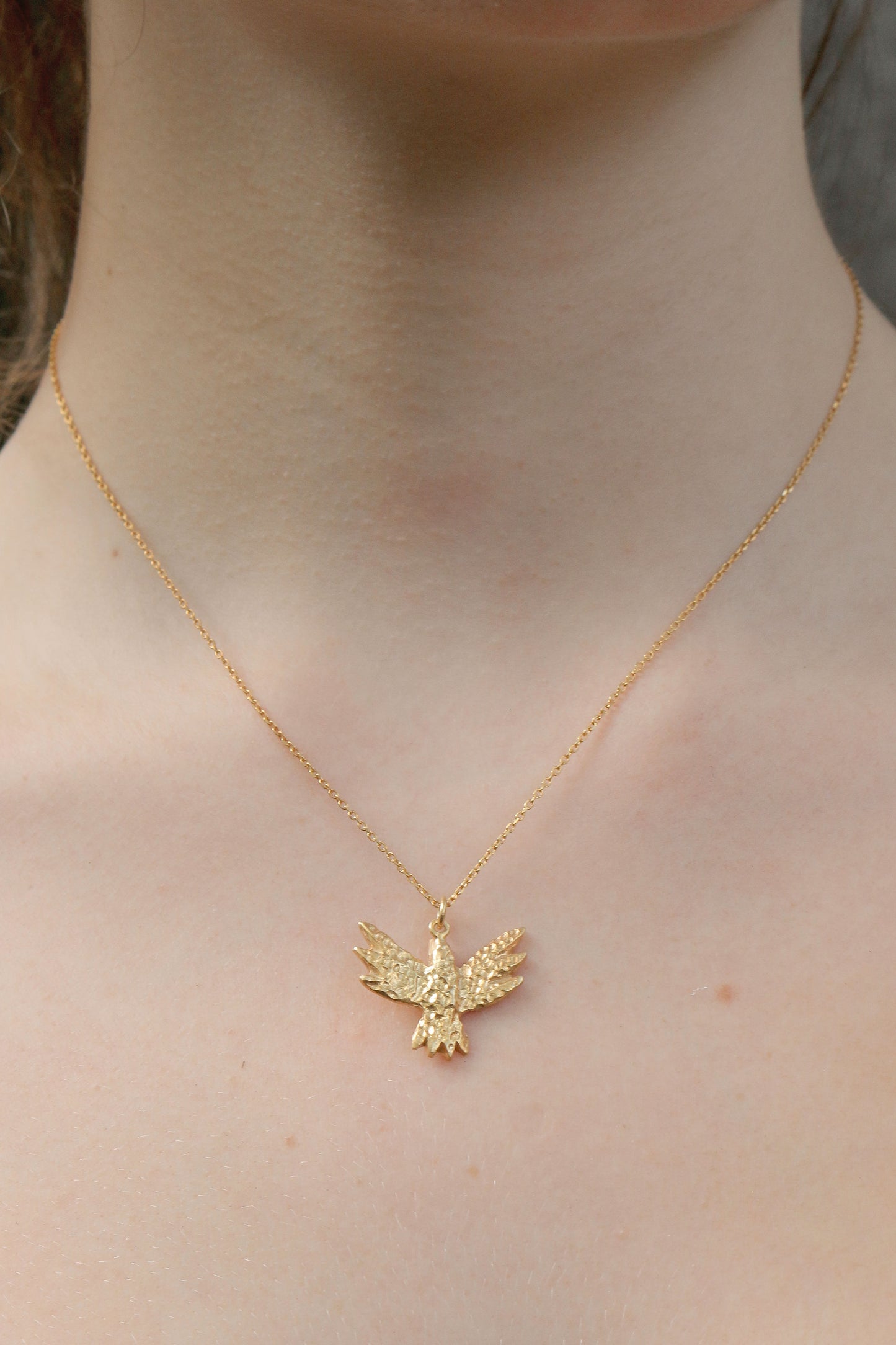 bird necklace on model