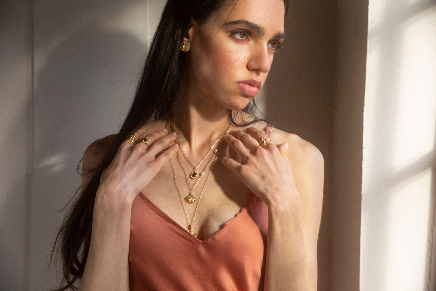 Gold necklace with garnet pendant lifestyle shoot